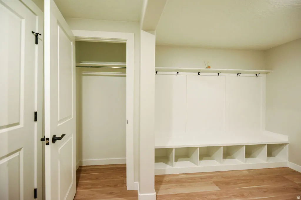 Built-in mudroom bench with open storage cubbies and coat hooks