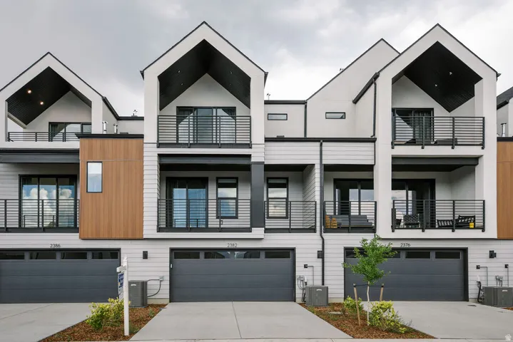 Contemporary townhome exterior featuring clean lines and a monochromatic palette
