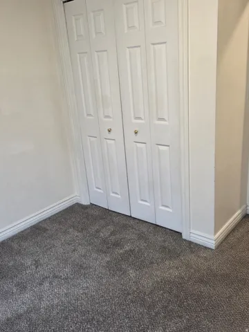 Bi-fold closet doors with panel detailing and gold-tone knob hardware