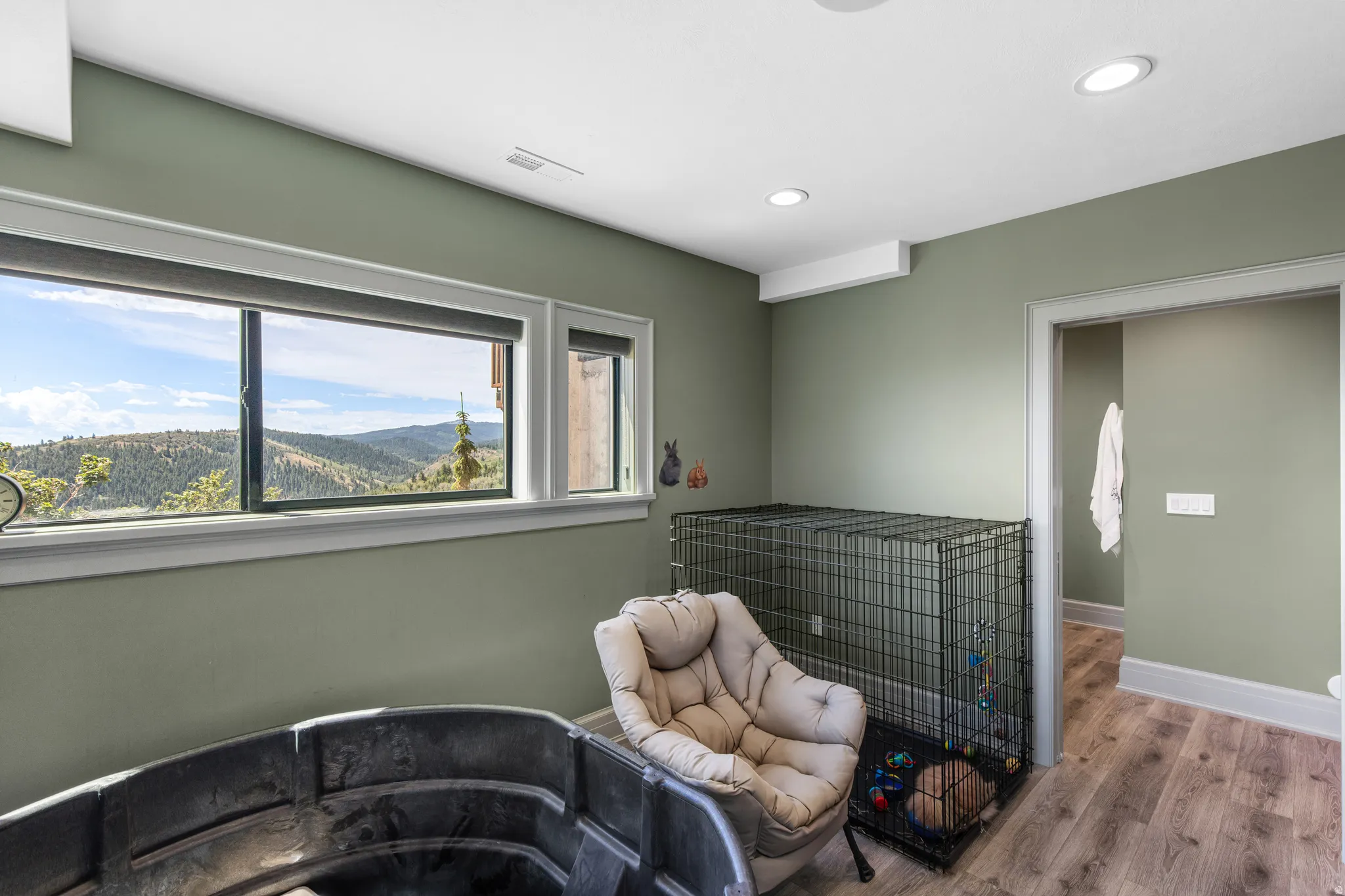 Room featuring wood-finish flooring, recessed lighting, and sage green walls