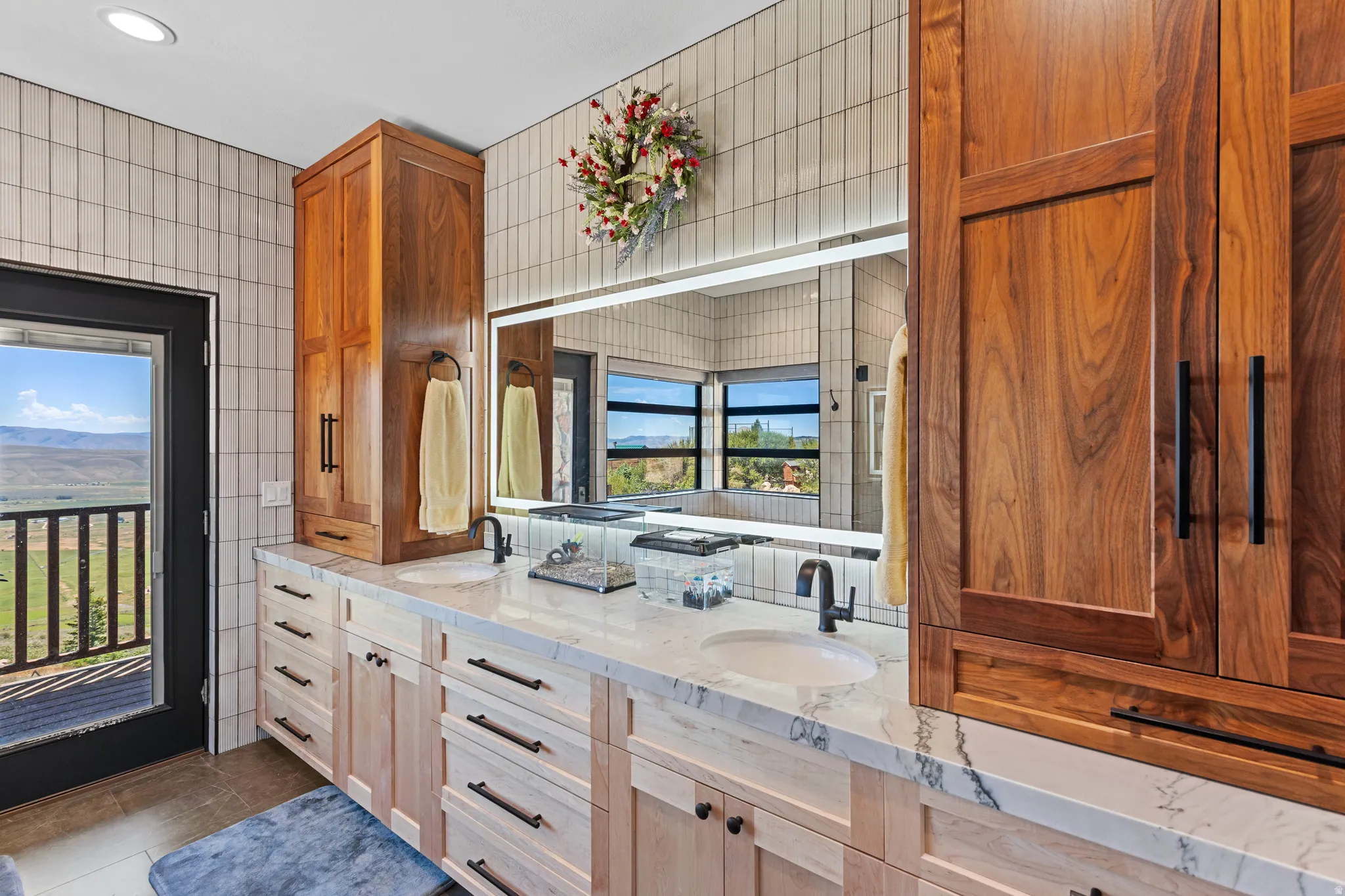 Bathroom featuring a double vanity with stone countertops, integrated sinks, and matte black fixtures