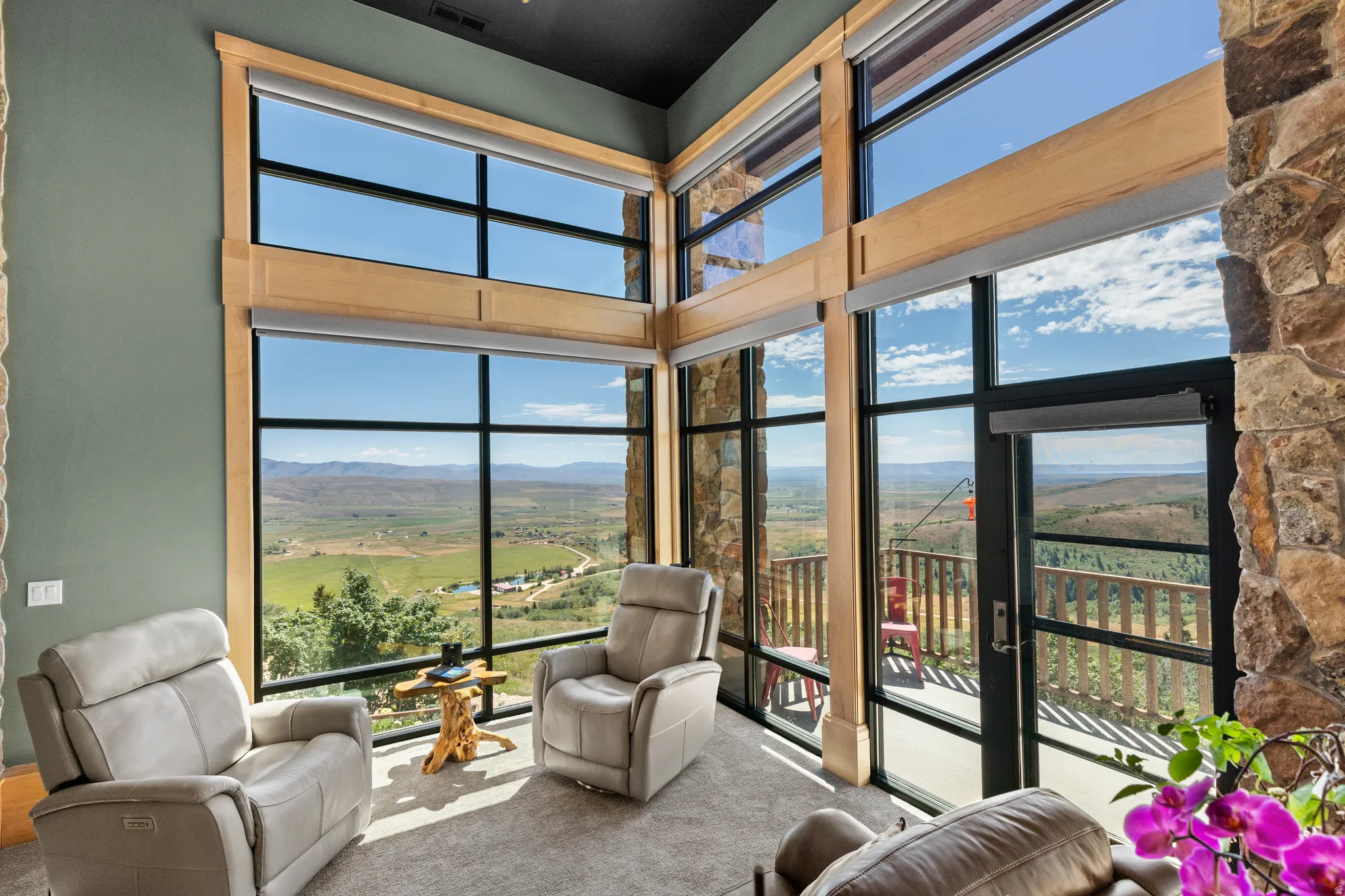 Two-story windows featuring wood framing and roller shades