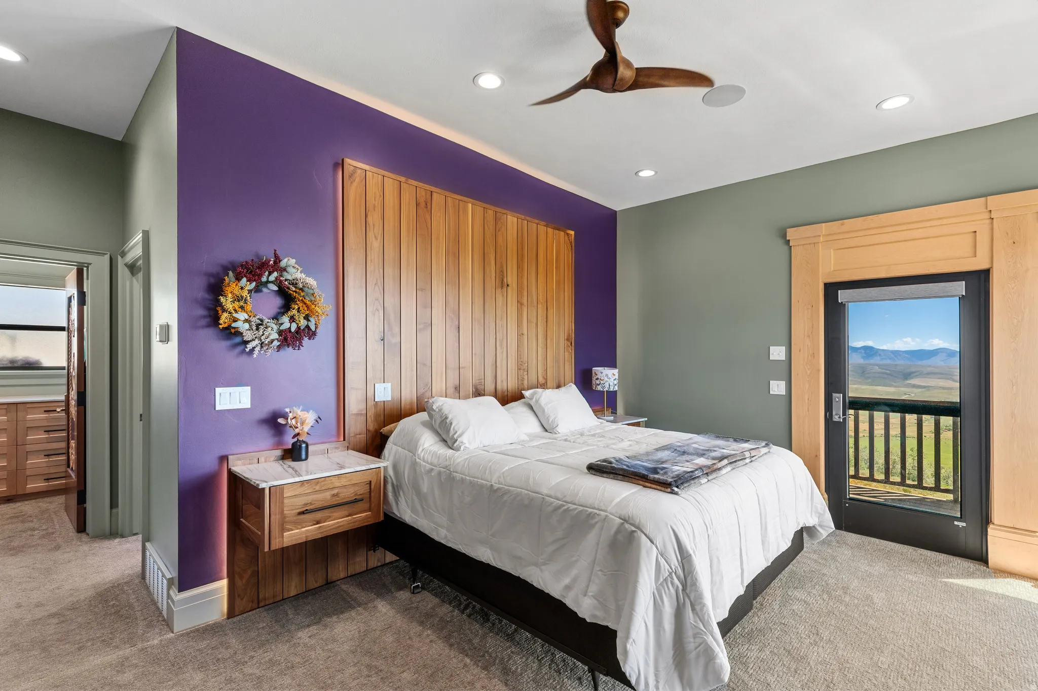 Bedroom featuring a wooden accent wall, recessed lighting, and a ceiling fan