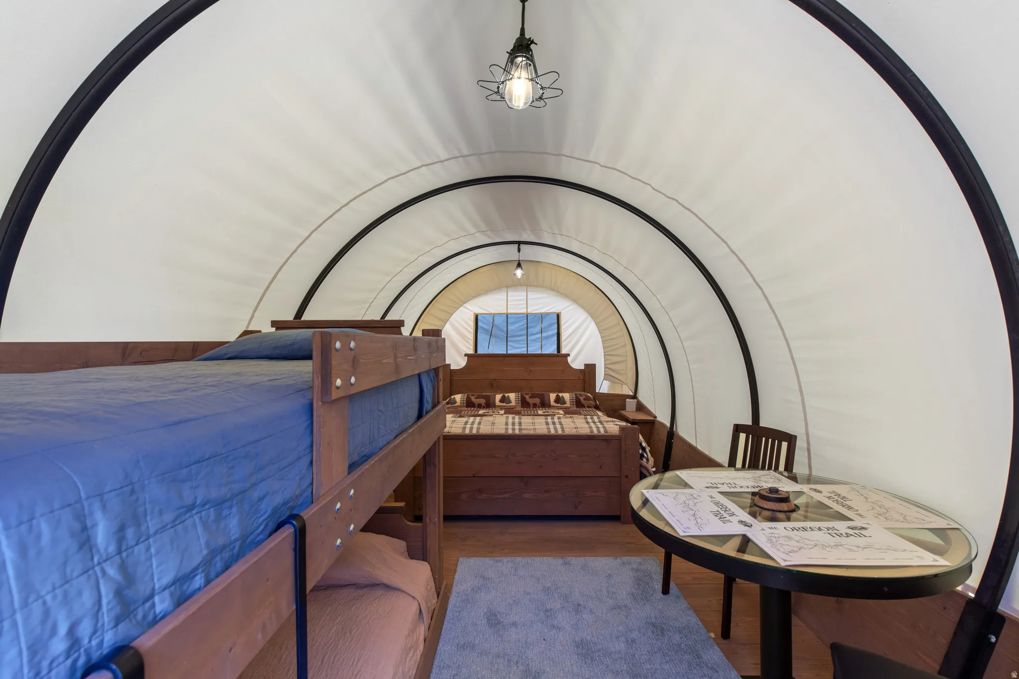 Arched interior with a white fabric ceiling and dark structural ribs