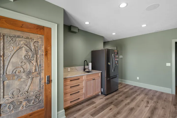 Custom wood door with carved details and metal accents