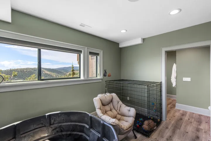 Room featuring wood-finish flooring, recessed lighting, and sage green walls
