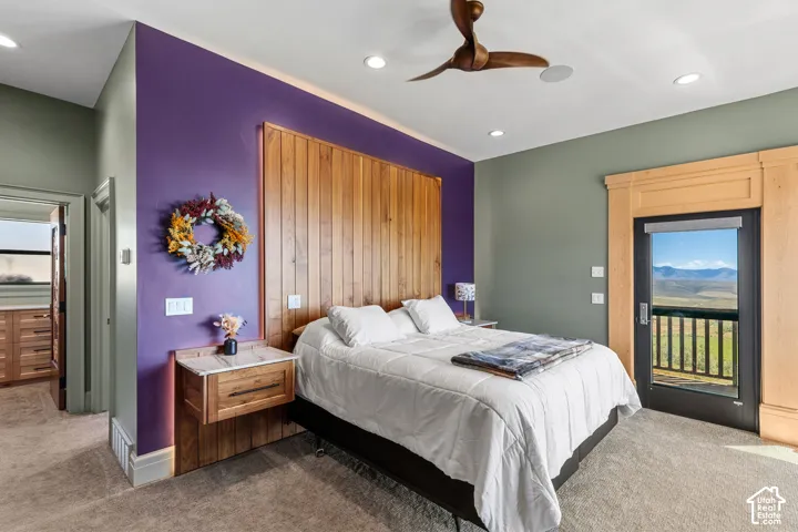 Bedroom featuring a wooden accent wall, recessed lighting, and a ceiling fan