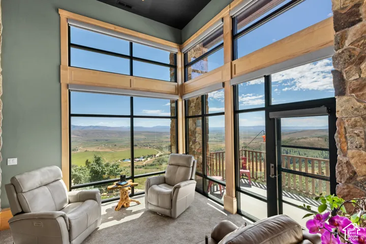 Two-story windows featuring wood framing and roller shades