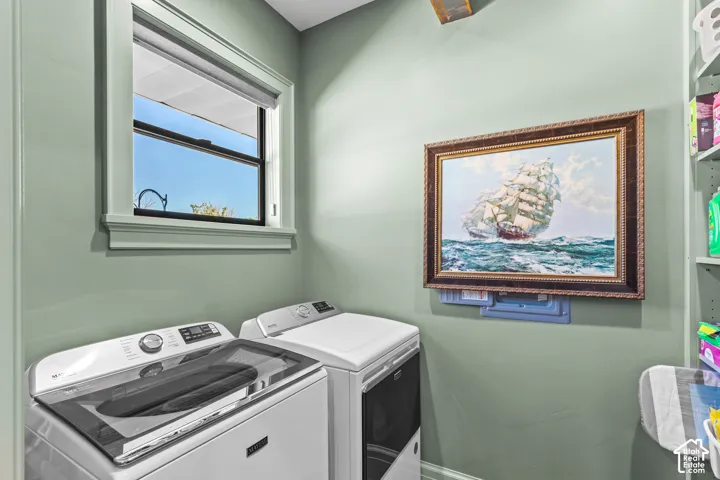 Laundry area with a single-pane window, light green painted walls, and built-in shelving