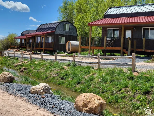 Multiple structures featuring wood siding and red metal roofs
