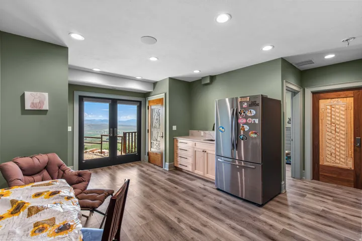 Interior space featuring wood-finish flooring, recessed lighting, and sage green walls