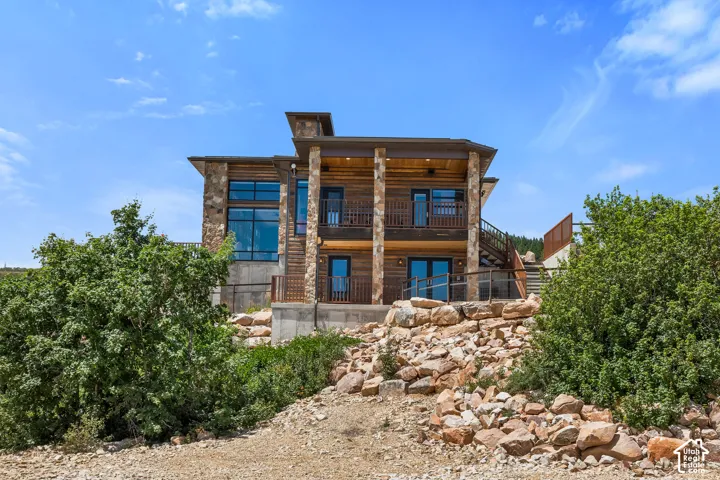 Multi-level residence featuring stacked stone and wood siding