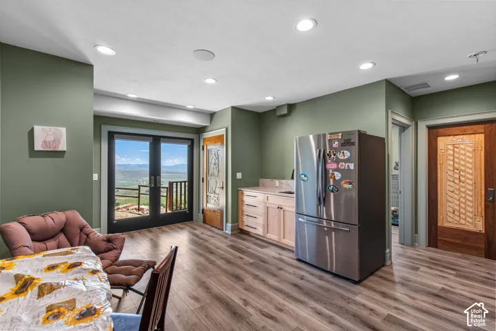 Interior space featuring wood-finish flooring, recessed lighting, and sage green walls