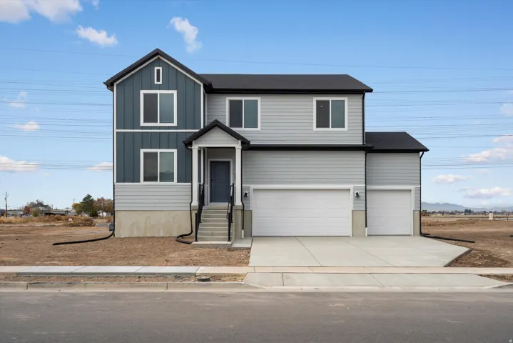 **DISCLAIMER** Exterior elevation may vary. Contemporary two-story residence featuring a two-tone exterior with light gray siding and vertical blue paneling
