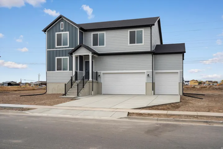 **DISCLAIMER** Exterior elevation may vary. Two-story residence featuring light gray siding and dark gray vertical accents