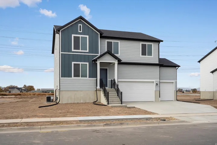 **DISCLAIMER** Exterior elevation may vary. Two-story residence featuring light gray and dark blue horizontal siding with vertical accent panels