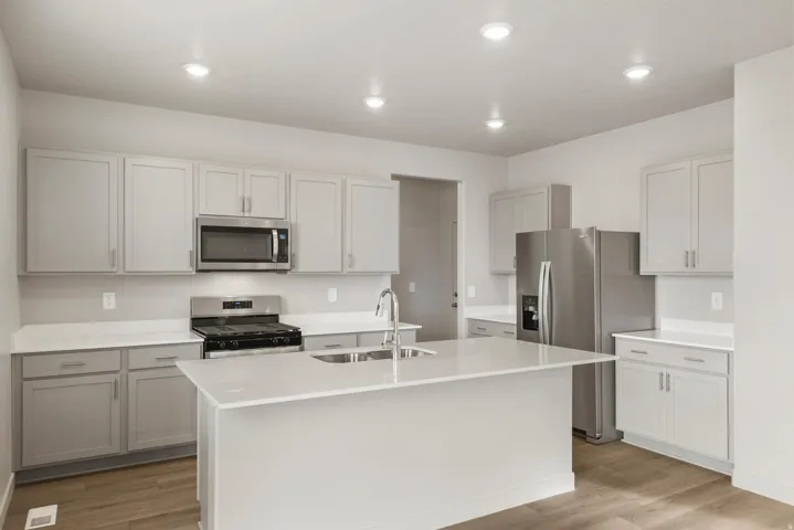 Modern kitchen featuring light gray cabinetry and white countertops