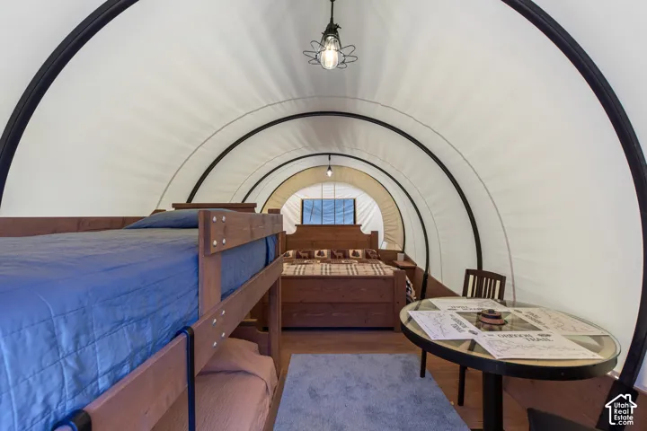 Arched interior with a white fabric ceiling and dark structural ribs