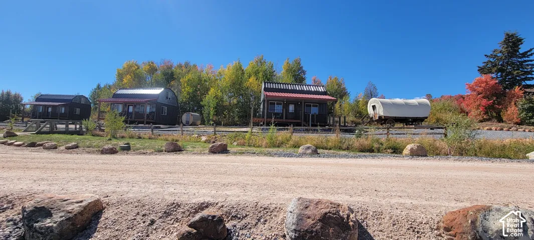 Multiple detached structures with covered porches, varied architectural styles, and elevated foundations