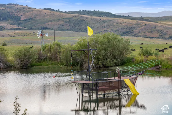 The Pirate Ship! A water feature with a custom boat-themed structure, featuring a yellow slide, metal railings, and a small dock