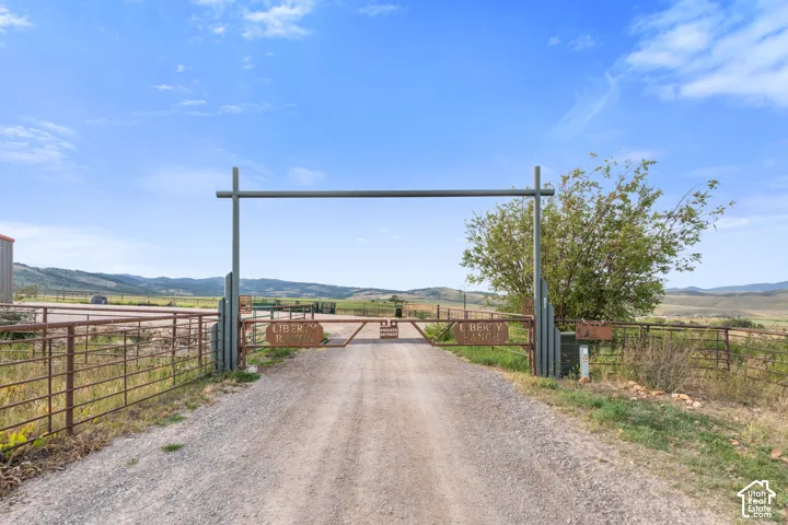 Liberty Ranch! Welcome, gravel driveway entrance featuring a metal overhead gate structure and fencing, Two New Pivots, new underground power on the ranch.