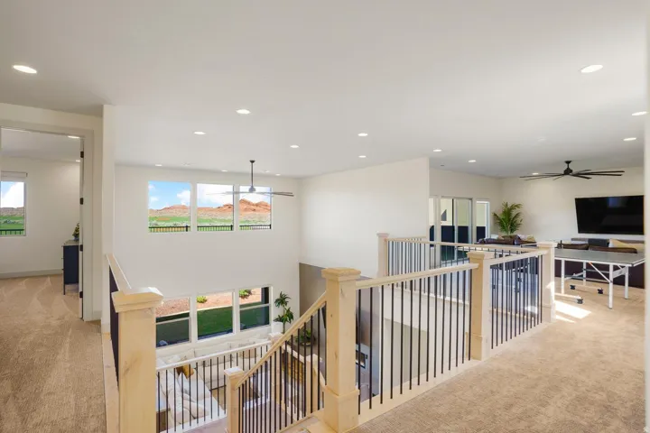 Upper level loft space featuring carpeted flooring and recessed lighting