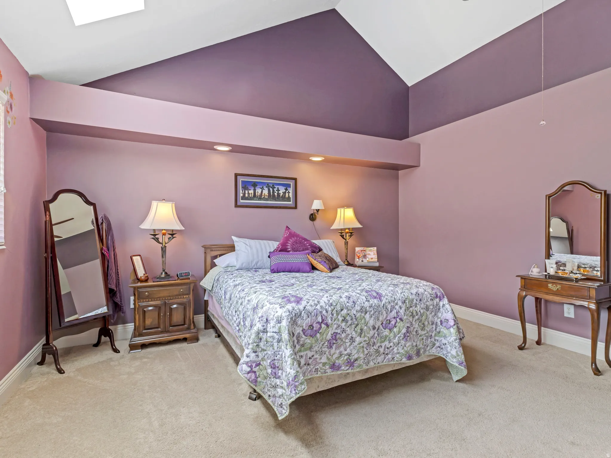 Spacious room featuring vaulted ceilings, a skylight, and recessed lighting