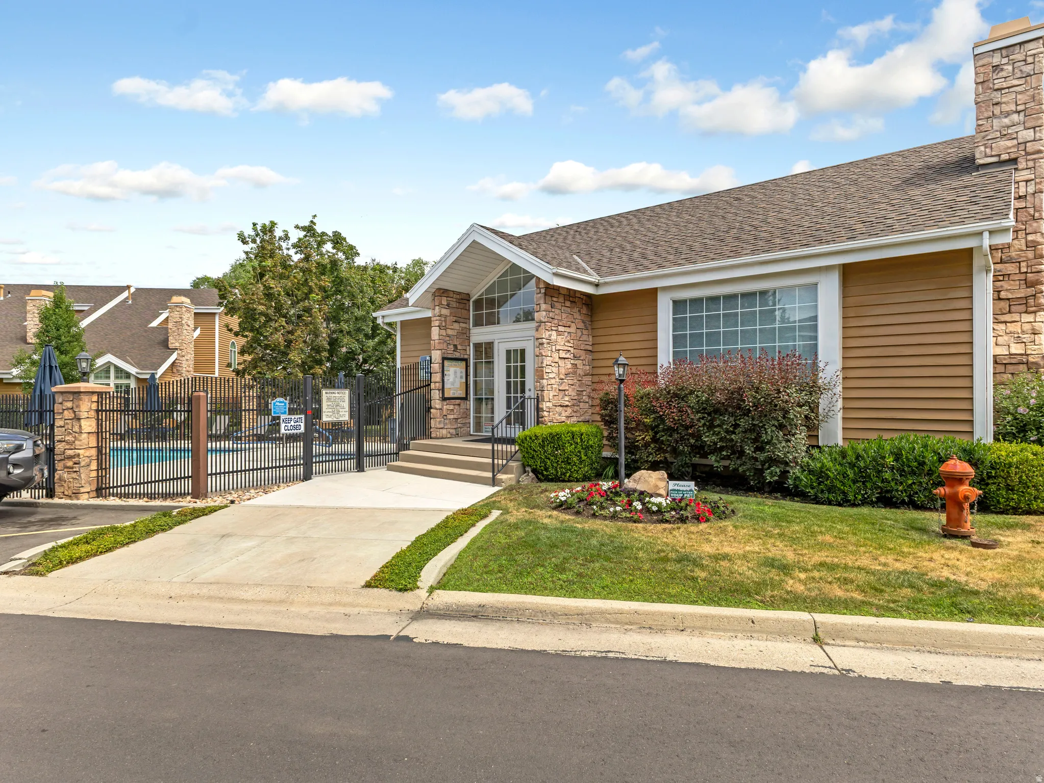 Building exterior featuring stone accents and wood-finish siding