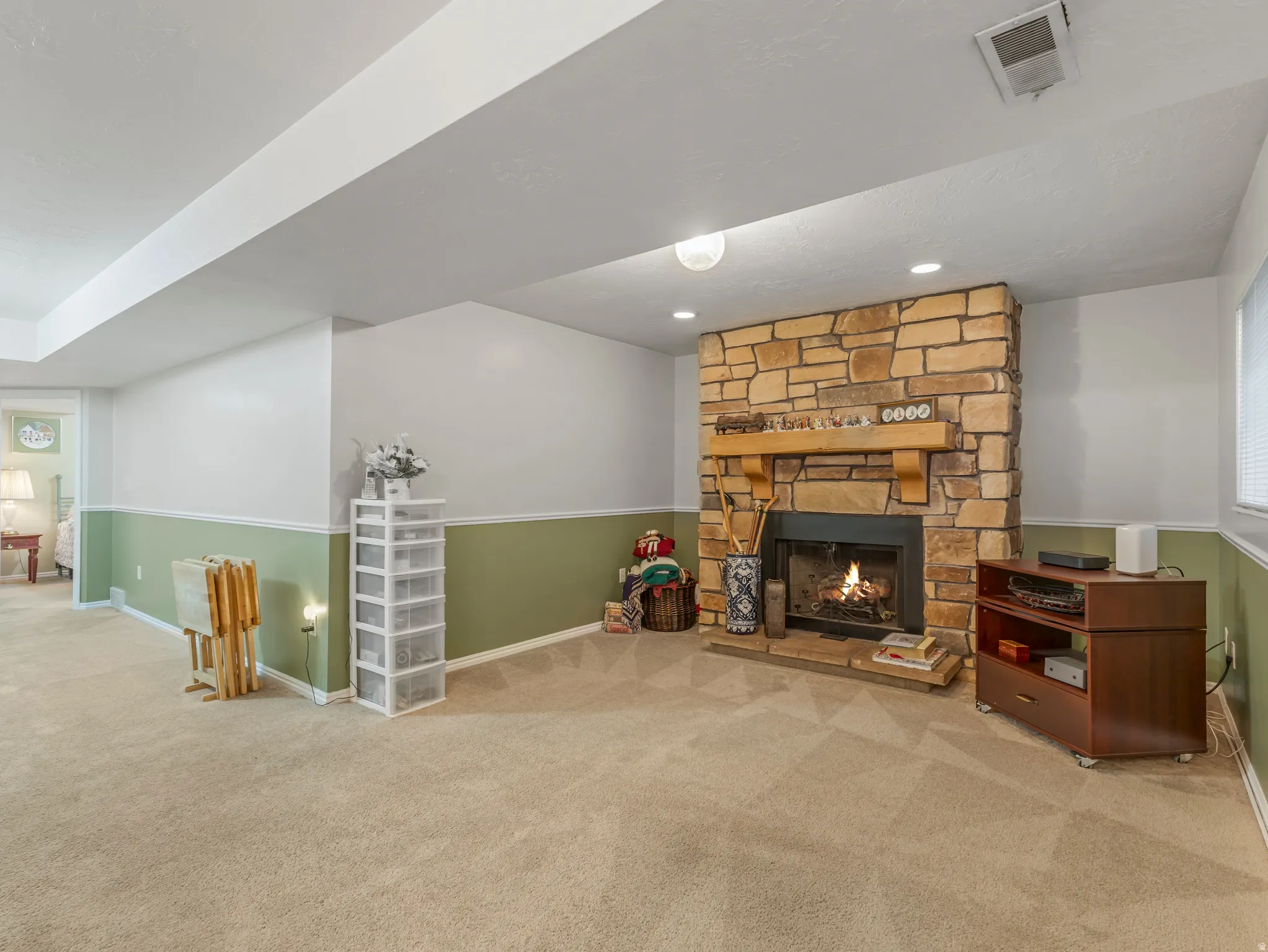 Stone-faced fireplace with a wood mantel