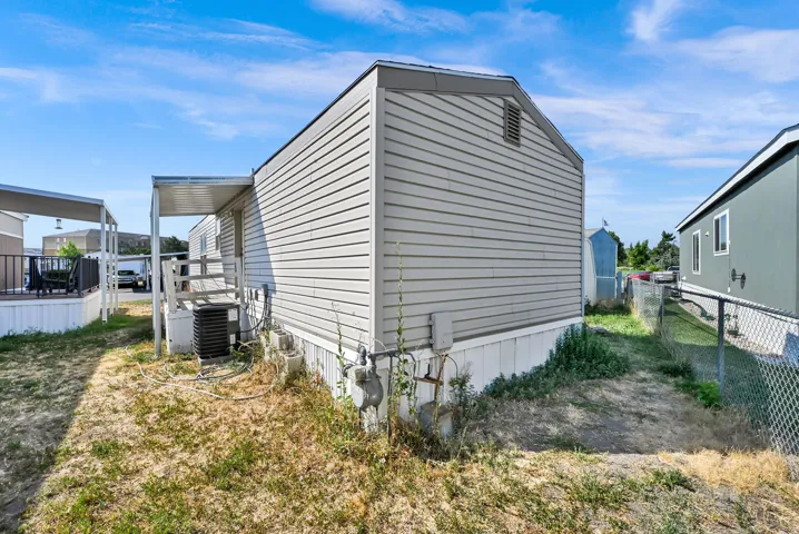 Exterior siding with a covered entry deck and an outdoor HVAC unit