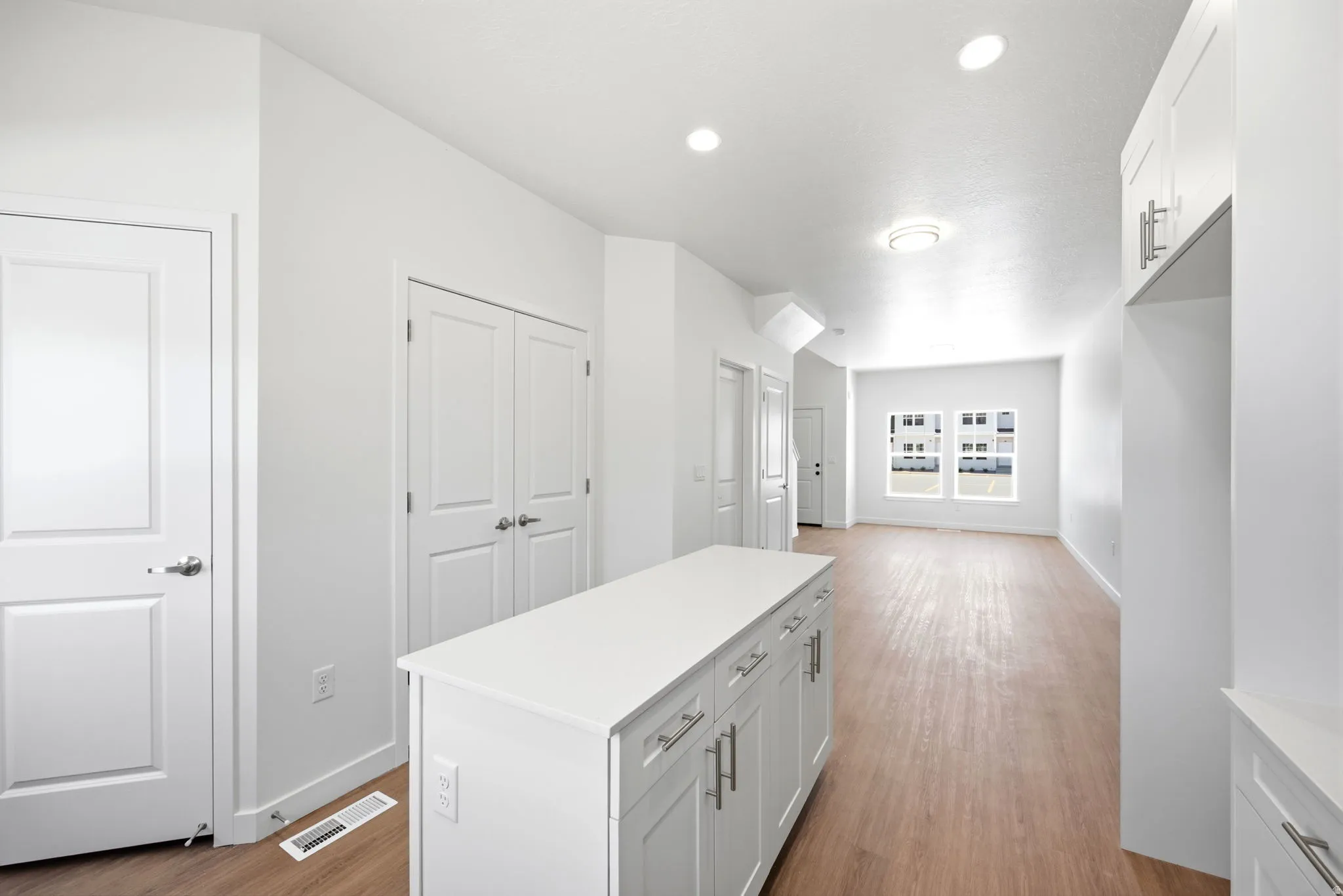 Bright interior featuring wood-finish flooring and recessed lighting