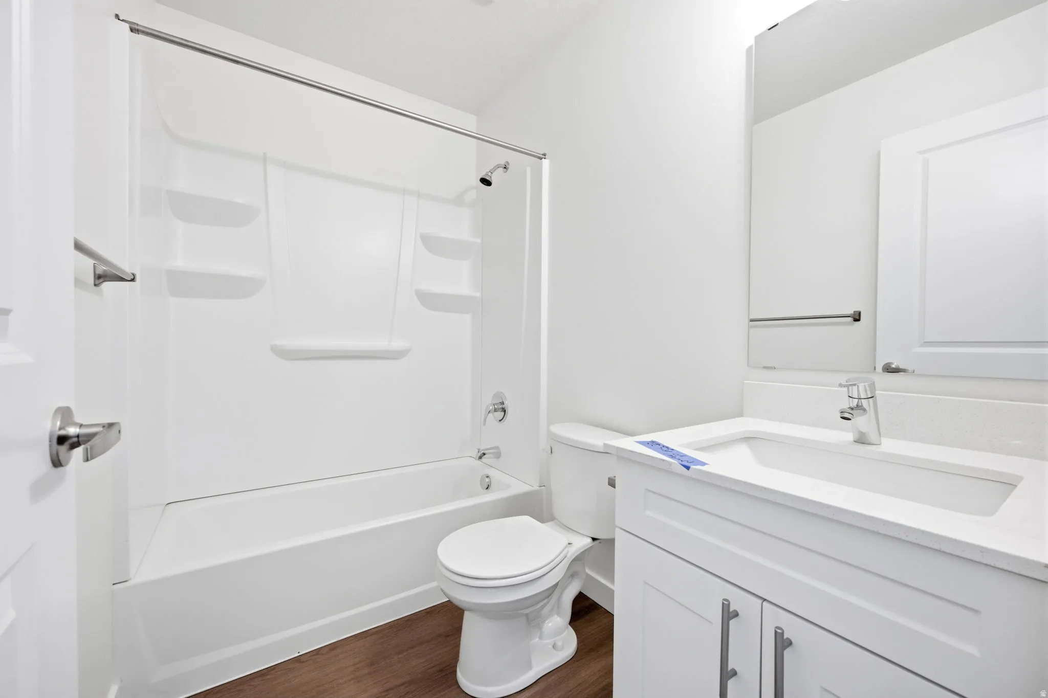Bathroom featuring a white bathtub and shower surround with integrated shelving