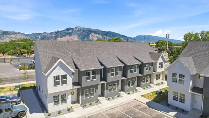 Contemporary townhome exteriors featuring gabled roofs and a mix of light and dark gray siding