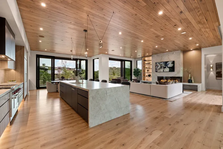 Open-concept living area featuring wood-finish flooring and a wood-paneled ceiling