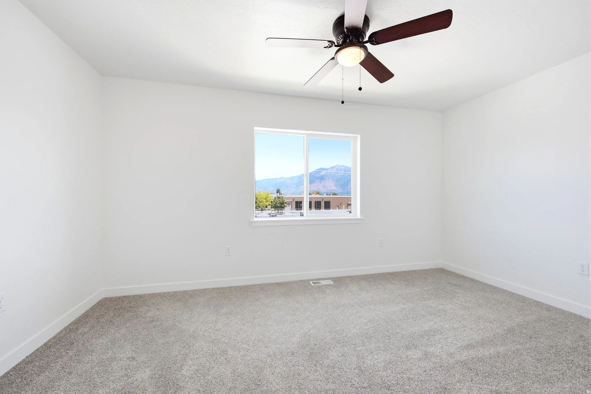 Bright room with plush gray carpeting and white walls