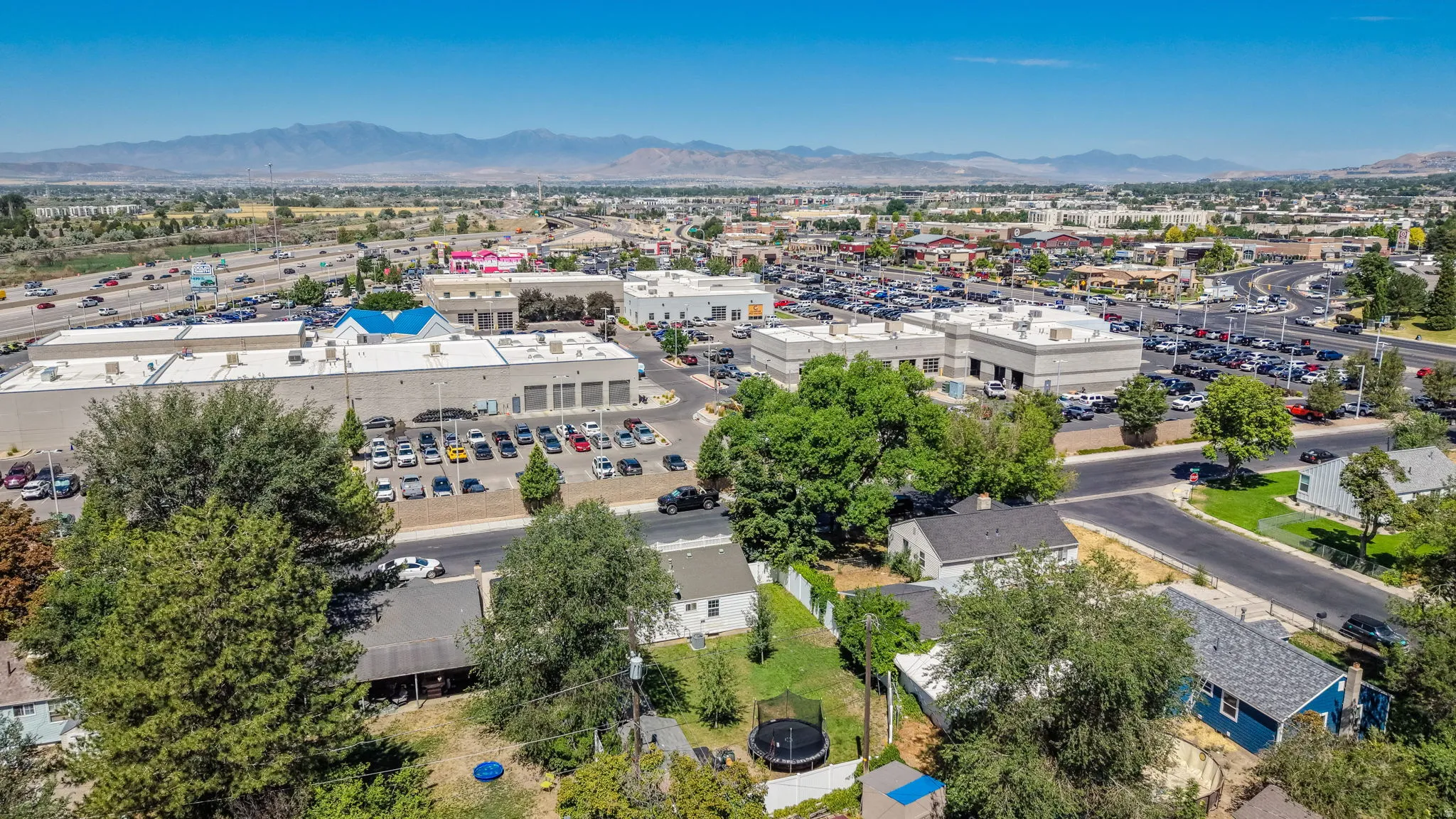 Aerial perspective showcasing a residential area interspersed with commercial buildings and roadways