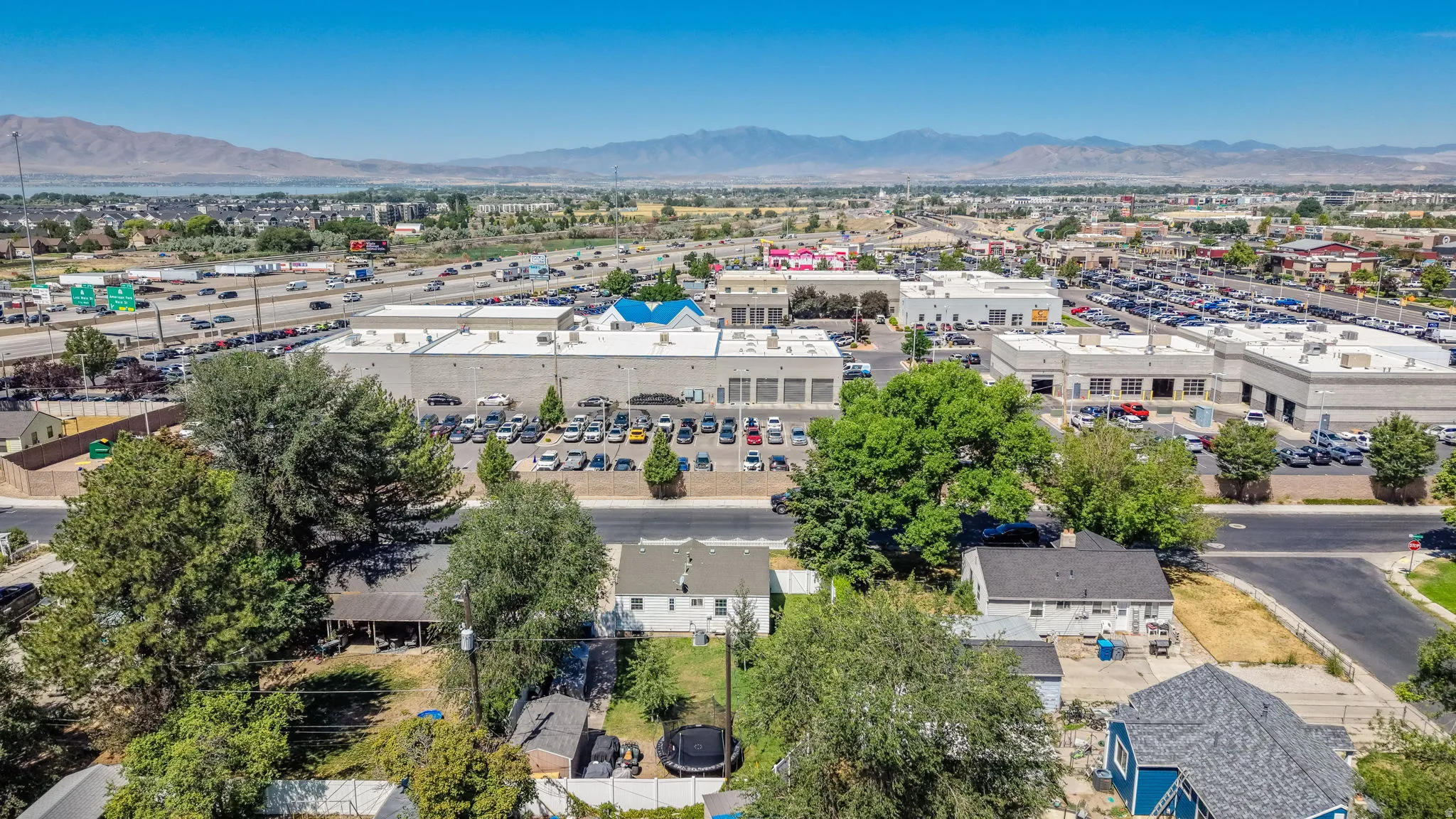 Aerial perspective showcasing multiple commercial buildings and residential properties