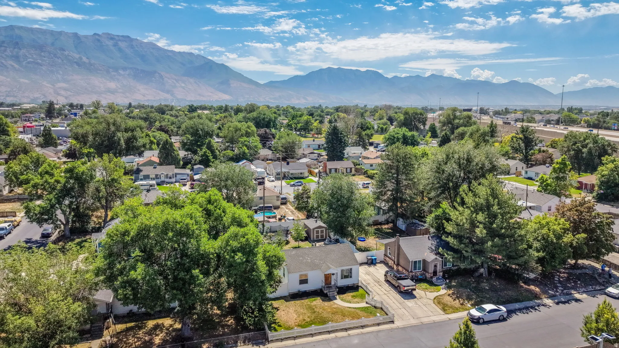 Aerial view showcasing the residential area with a prominent mountain range backdrop