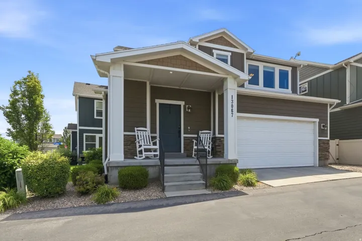 Modern exterior featuring horizontal siding, natural stone accents, and a covered porch