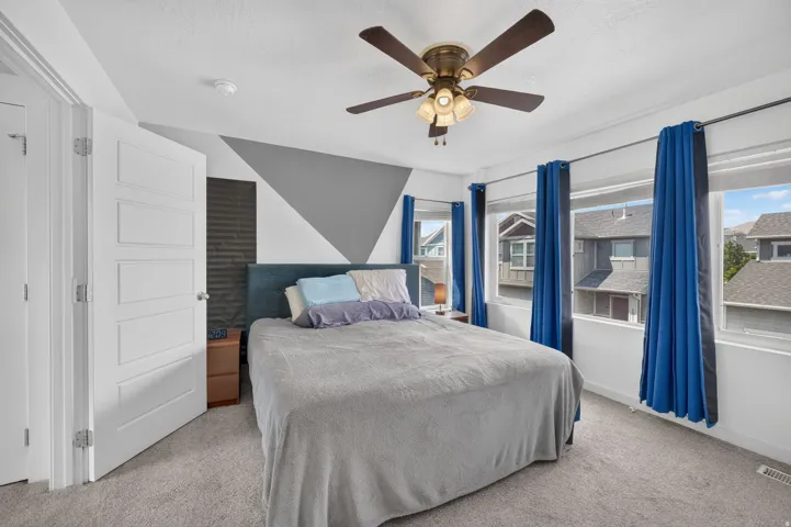 Bedroom featuring carpet flooring and multiple windows
