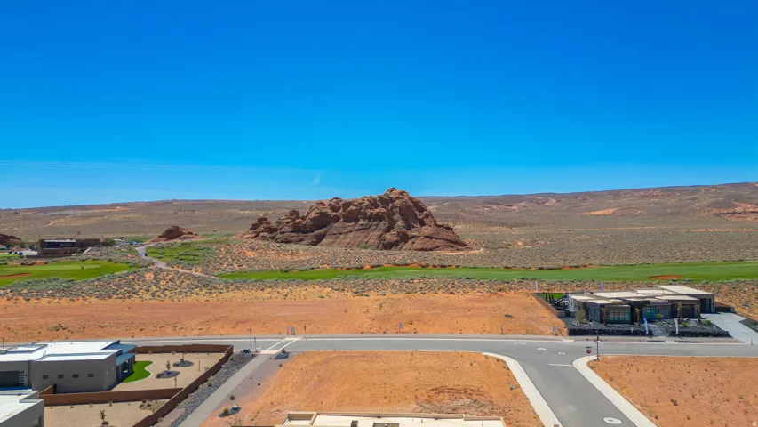 Modern desert community featuring a golf course, distinctive rock formations, and contemporary architecture