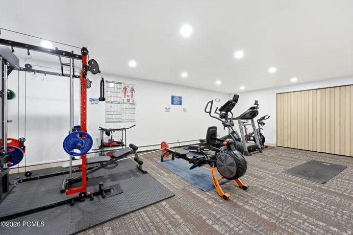 Dedicated fitness space featuring carpet flooring and recessed lighting