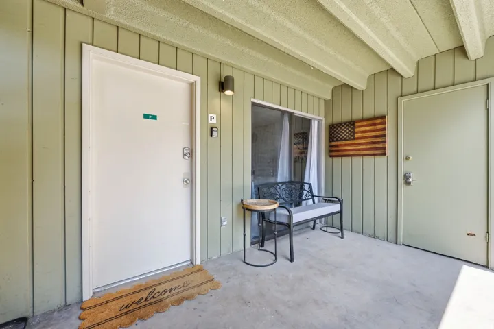 Covered entryway featuring vertical siding and a concrete patio