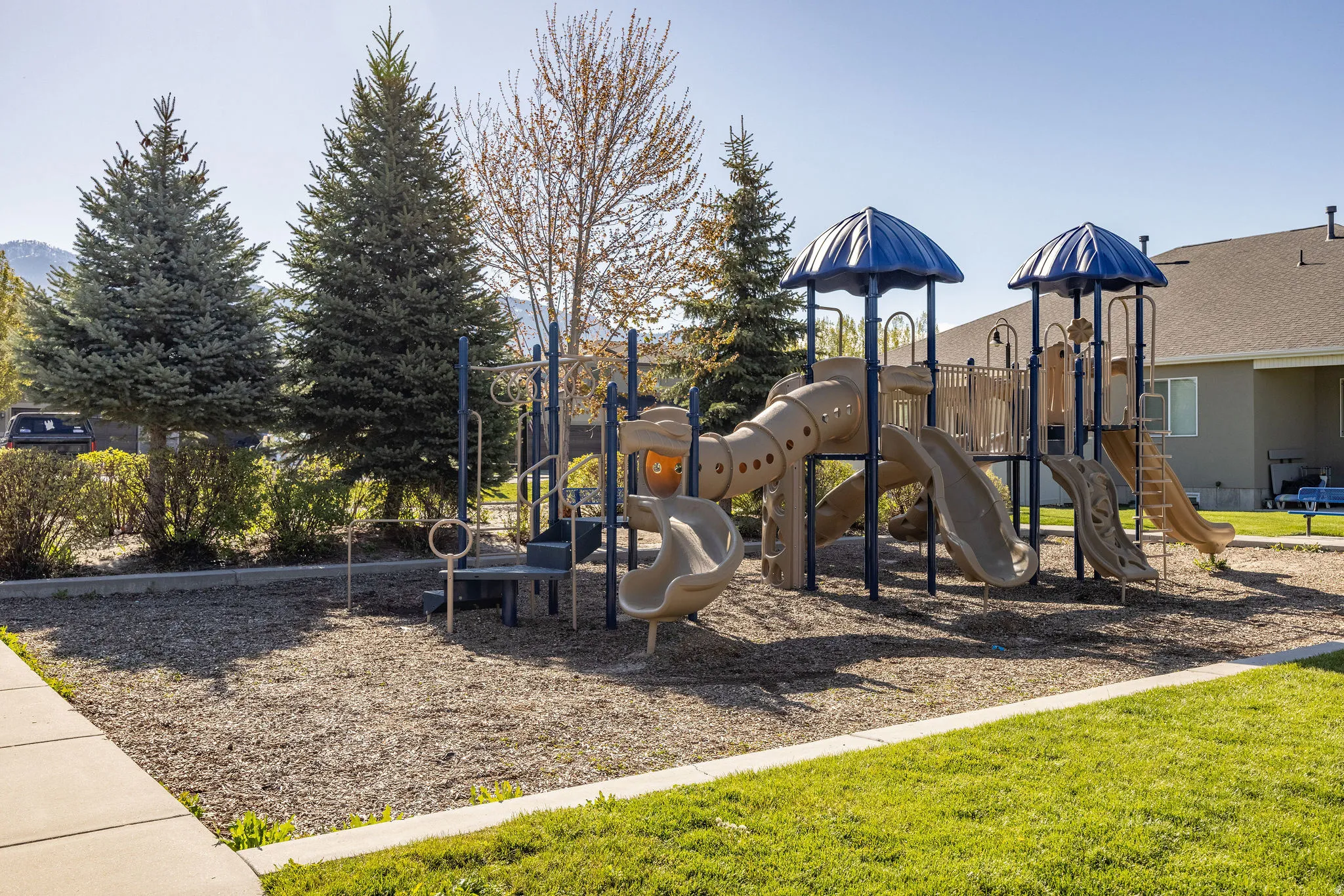 Community playground featuring multiple slides, climbing structures