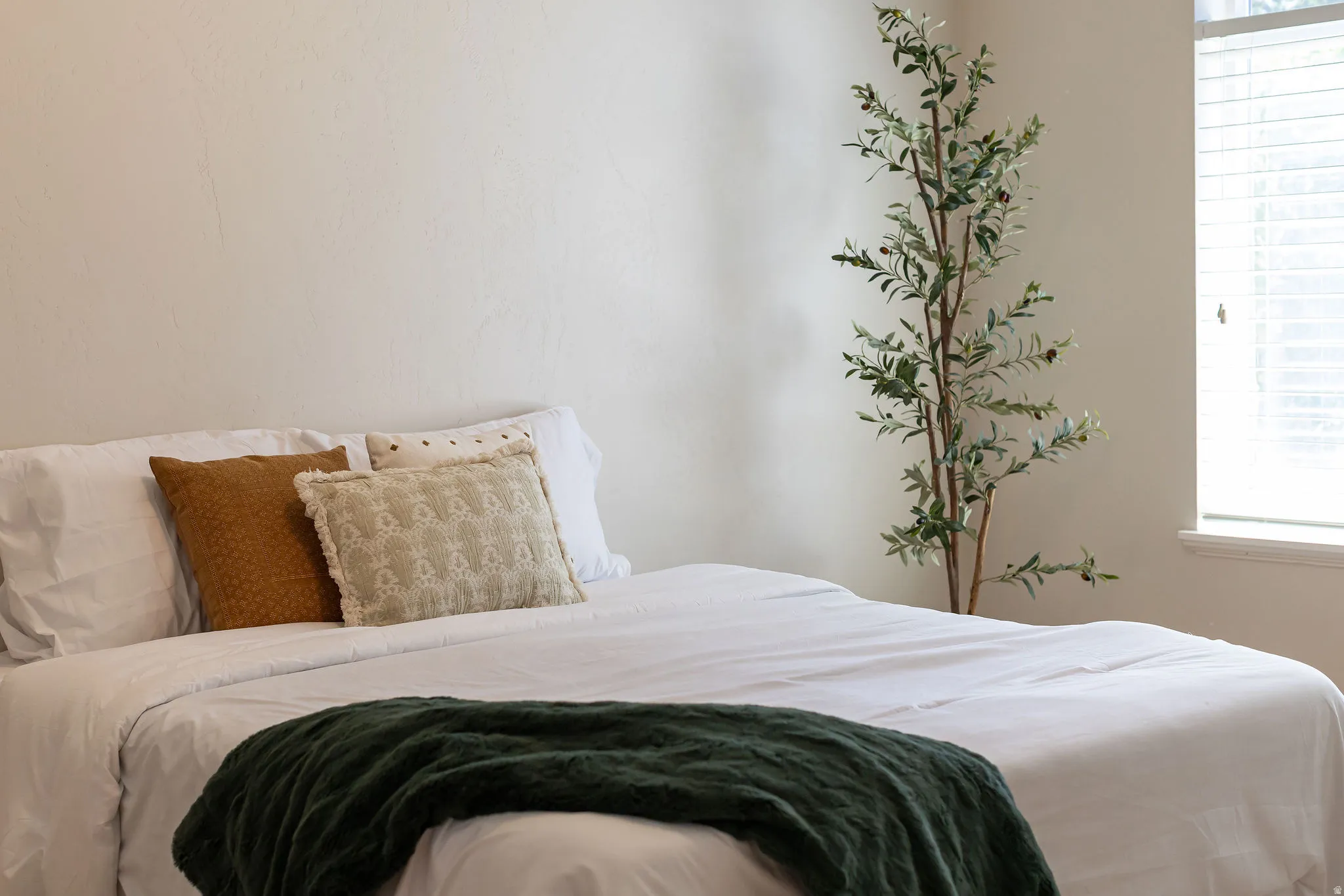 Neutral wall tones complement natural light from the window