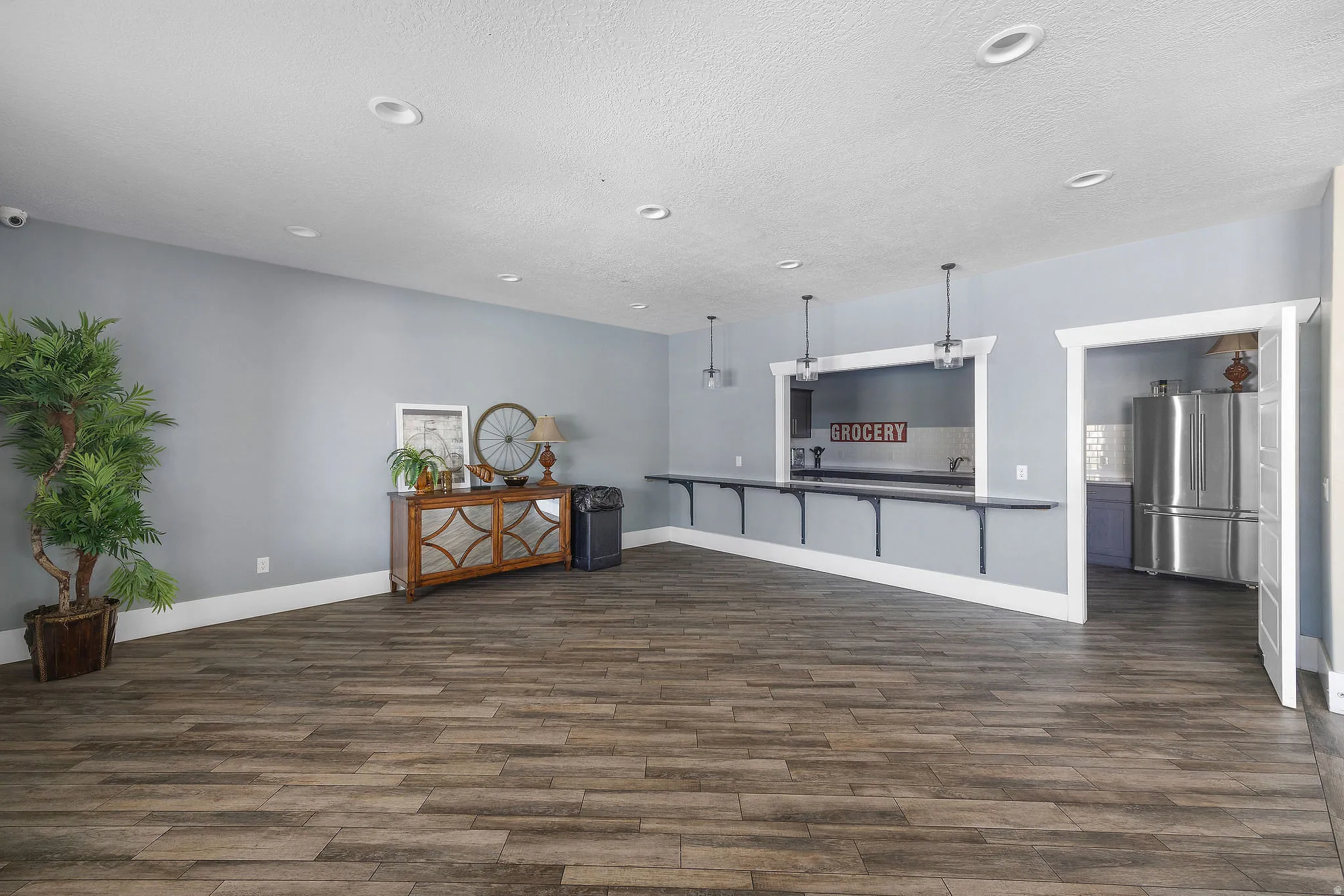 Clubhouse room featuring wood-finish flooring, recessed lighting, and light blue walls