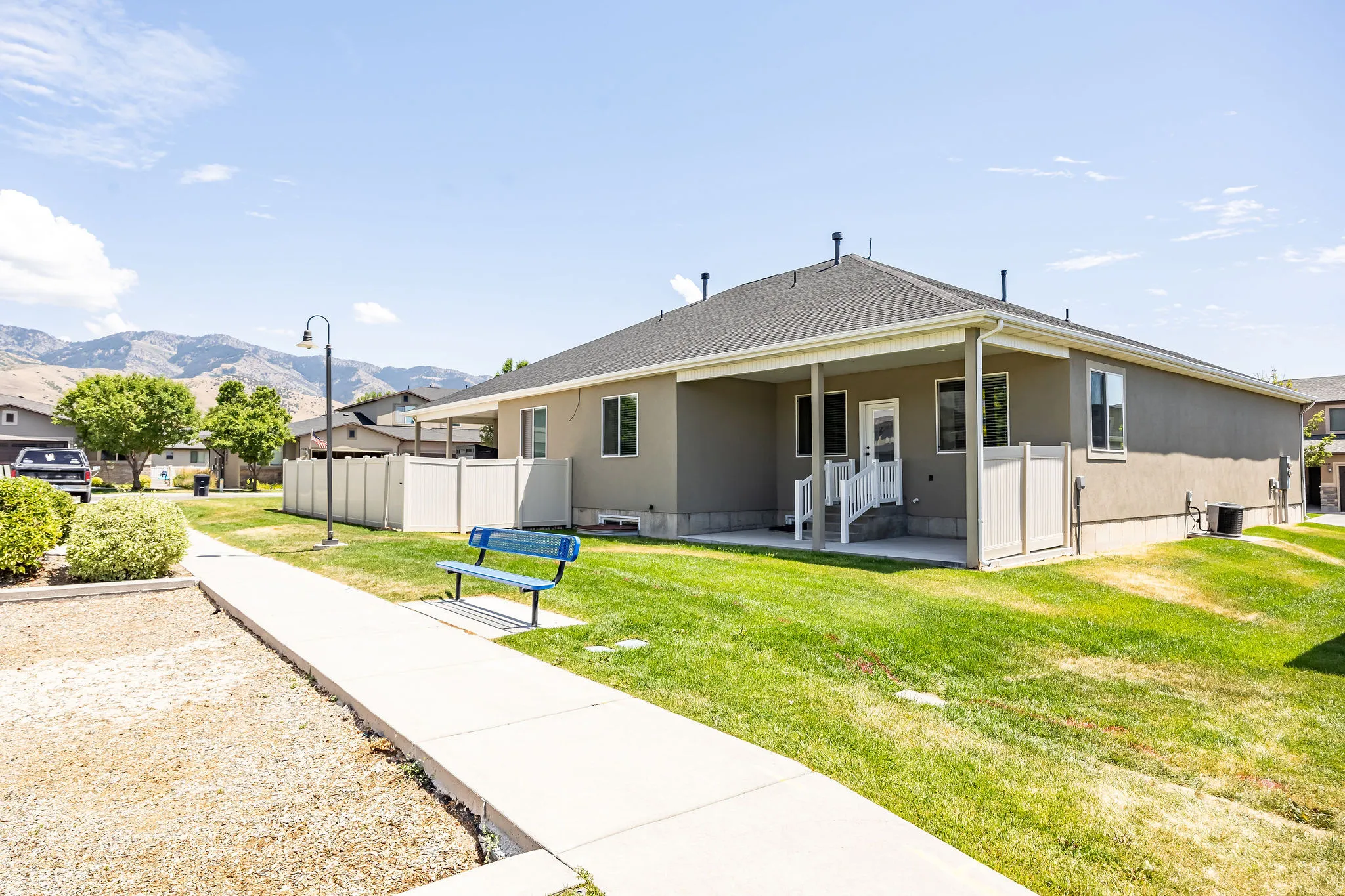 Rear exterior with covered patio, stucco siding, and a fenced perimeter