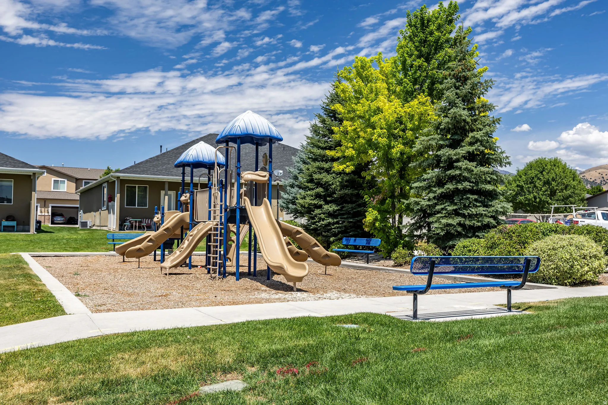 Community playground featuring multiple slides and climbing