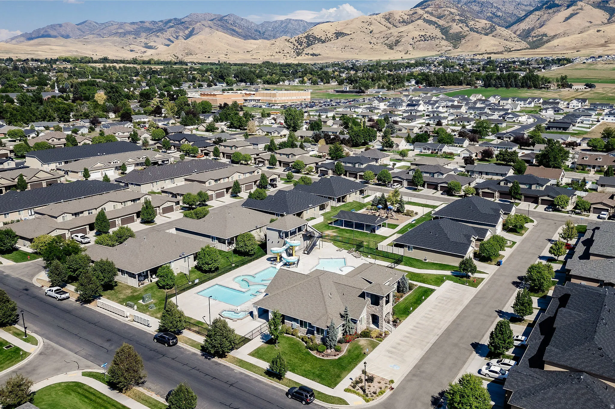 Aerial perspective showcasing a residential community with varied rooflines and landscaping