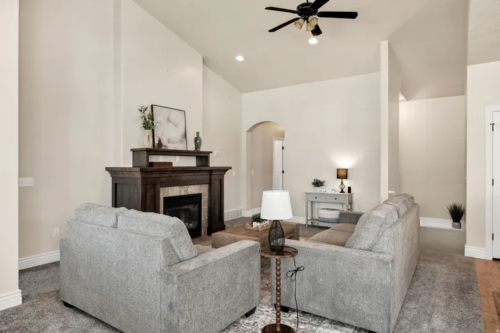 Living room featuring a dark wood-finish mantel with a tile surround fireplace